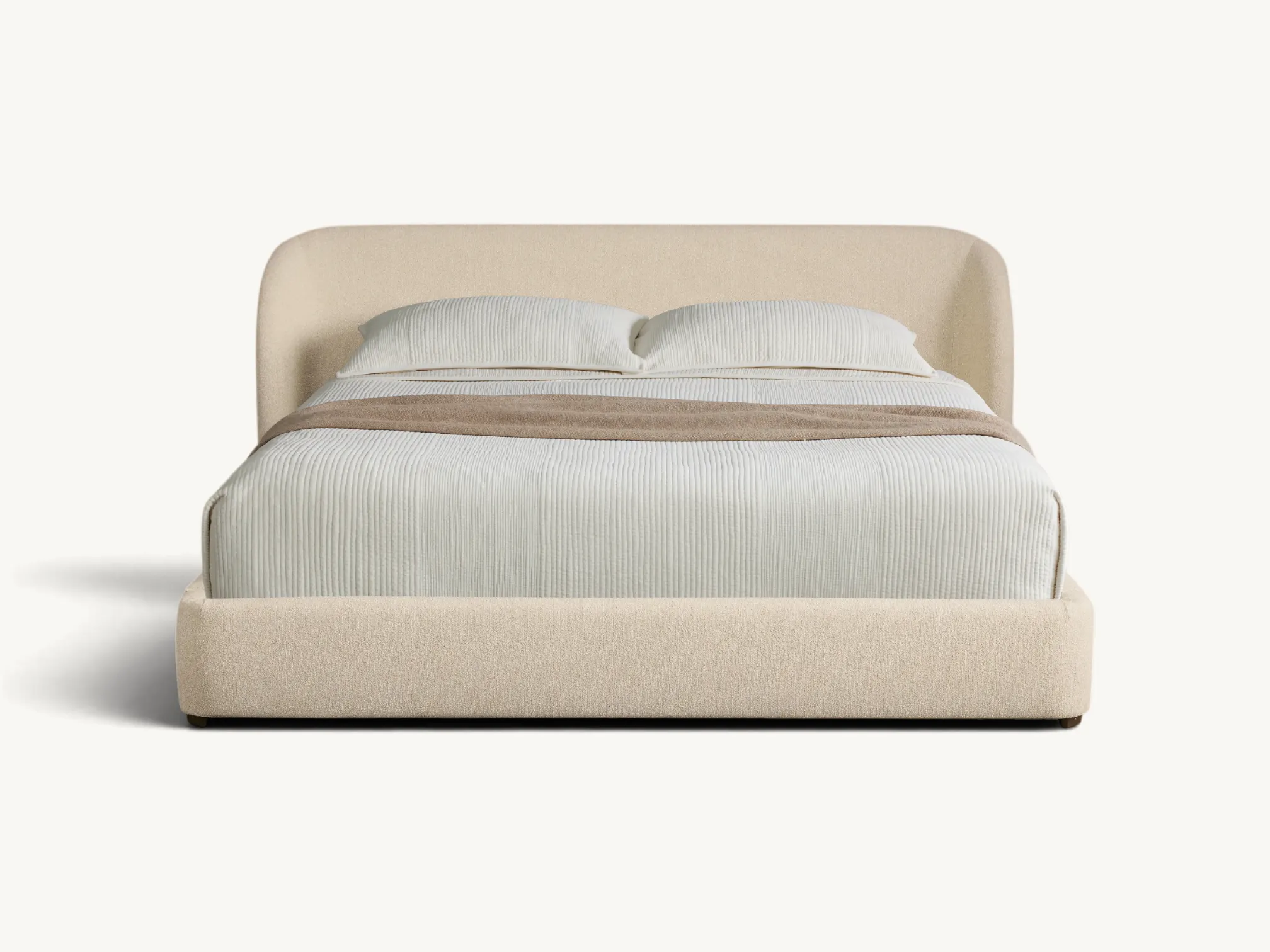 Japandi style platform bed with rounded cream bouclé upholstered headboard and internal teak wood frame.