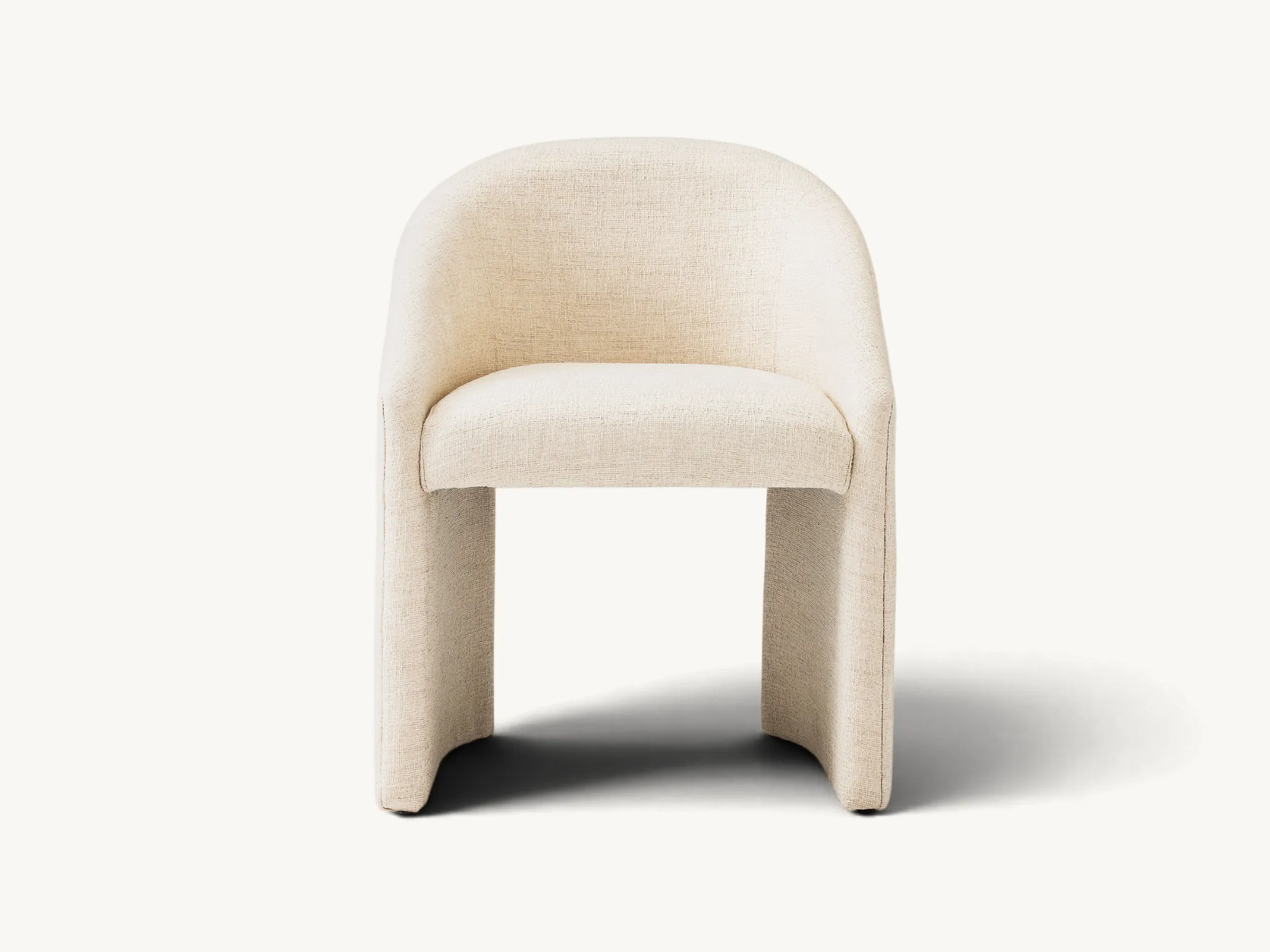 Modern fully upholstered dining chair in cream fabric with a wrap-around backrest and teak wood internal frame.