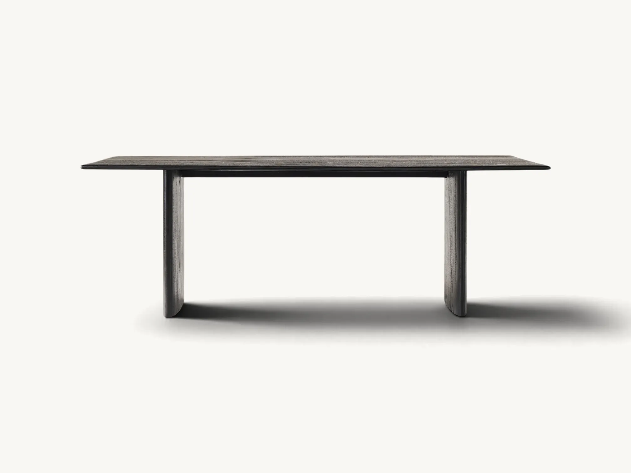Minimalist solid teak dining table with black finish and rectangular slab legs.