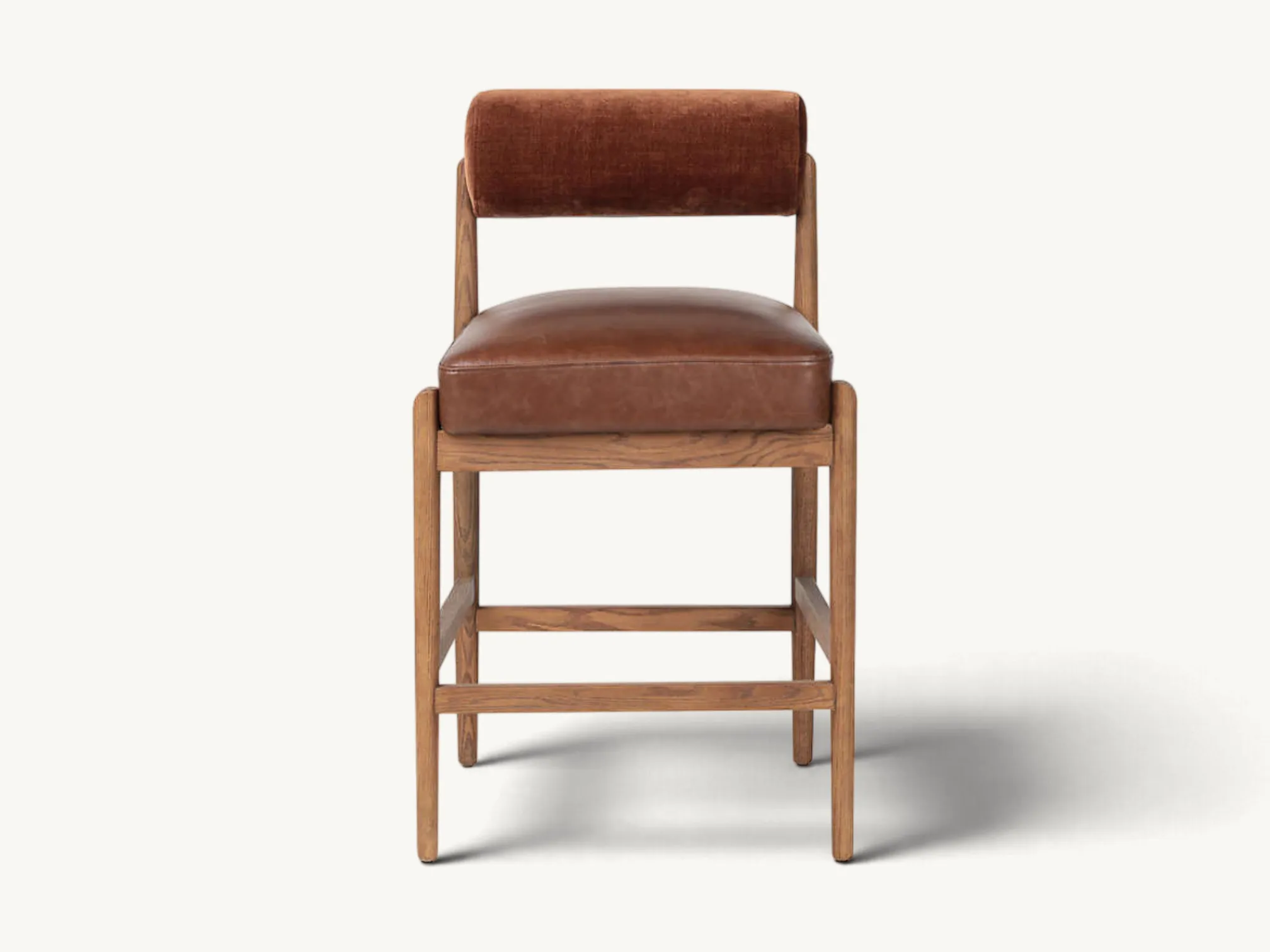 Wooden counter stool featuring a cushioned brown leather seat and a rust-brown velvet cylindrical bolster backrest