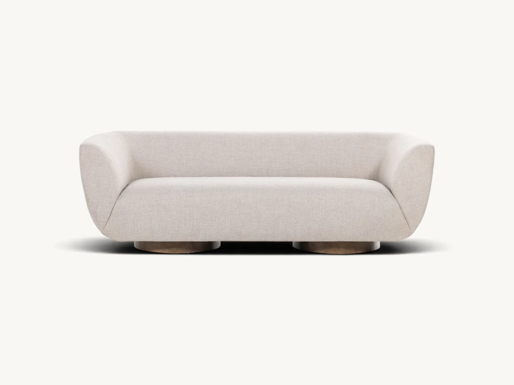 Modern curved sofa with light beige upholstery and circular teak wood pedestal base.