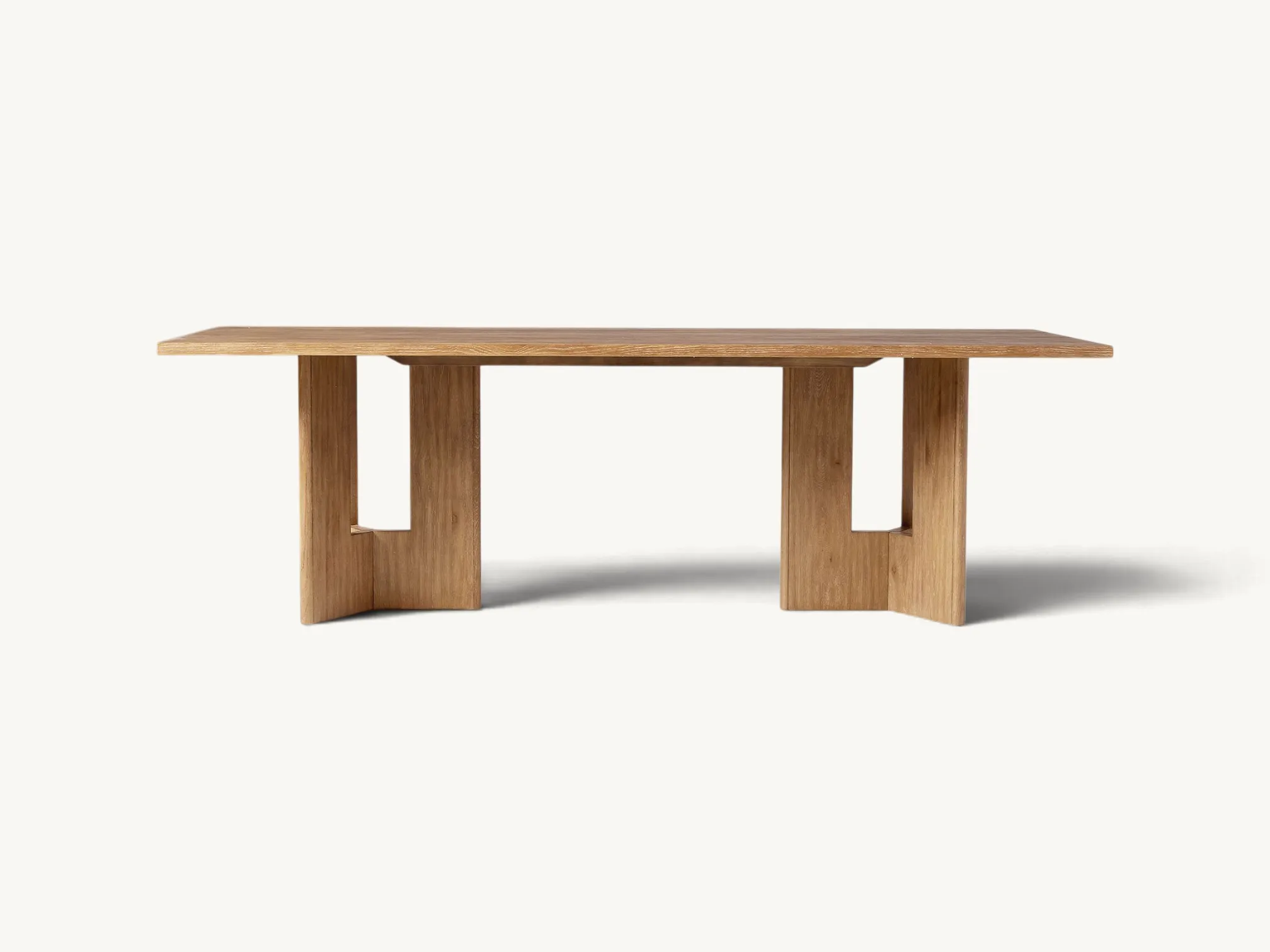 Modern solid teak dining table with unique architectural pedestal base.