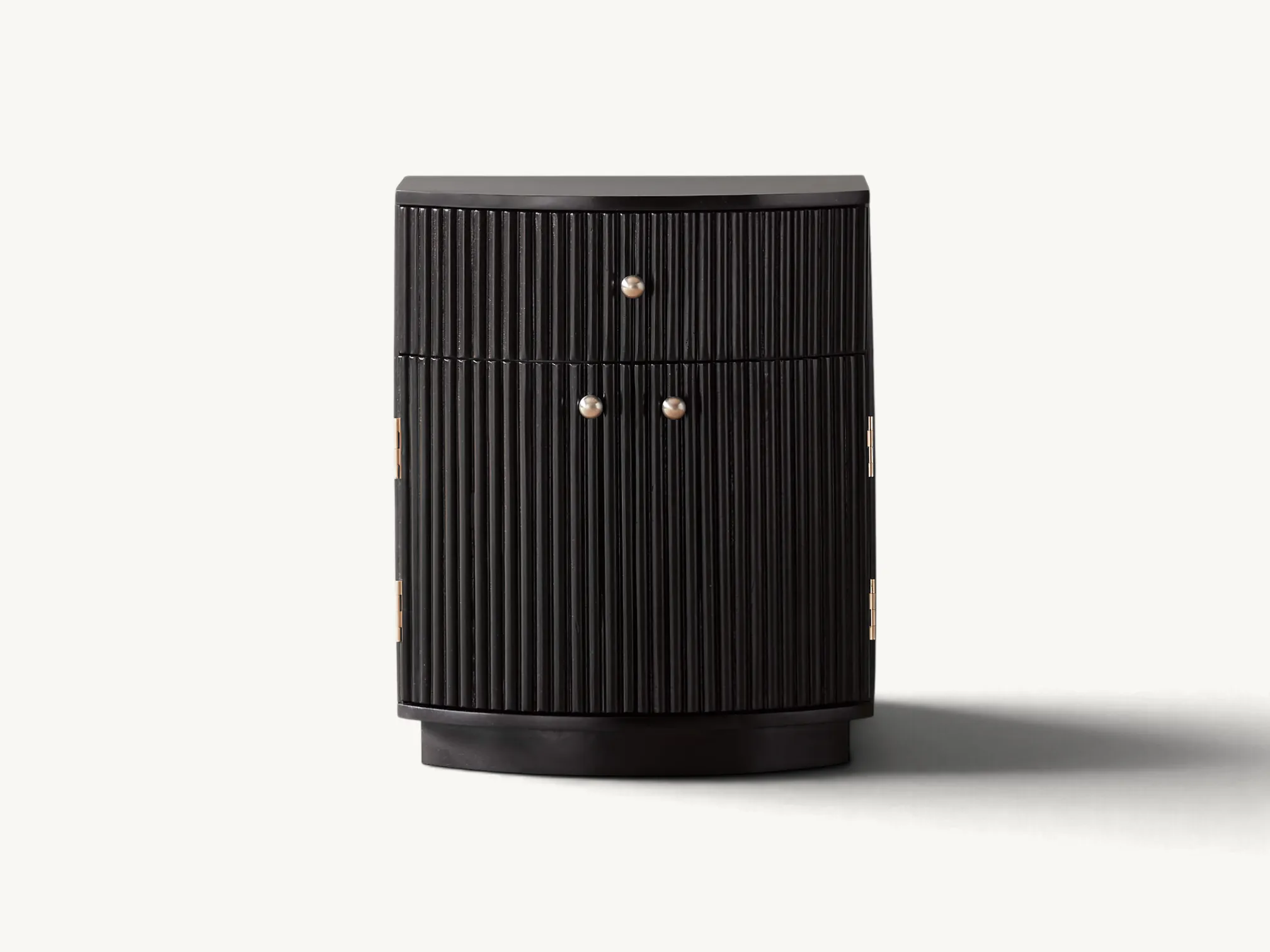 Black fluted curved nightstand with top drawer, two doors, and round metal knobs