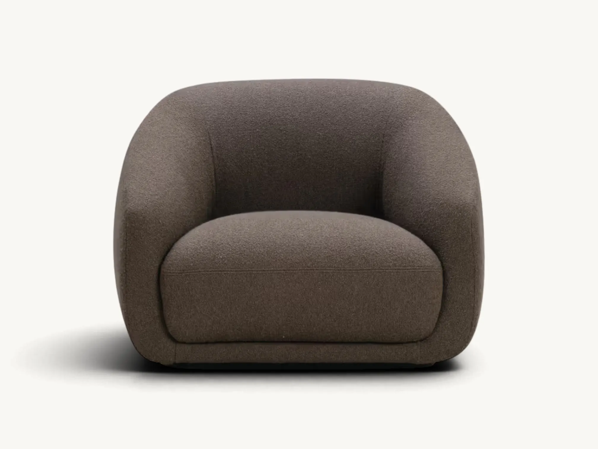 Modern curved lounge chair with dark brown textured fabric upholstery in a minimalist white interior setting.