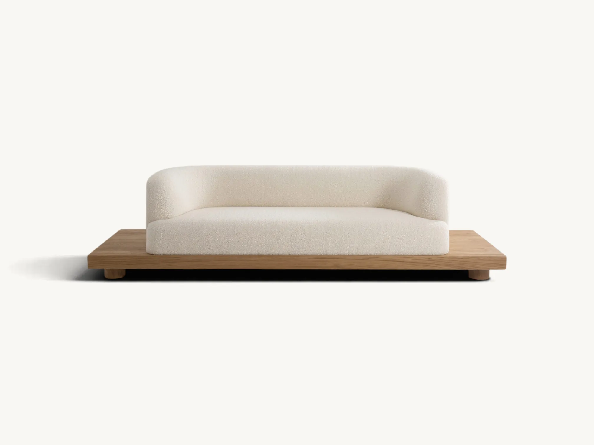 Minimalist curved bouclé sofa on a low-profile solid teak wooden platform.