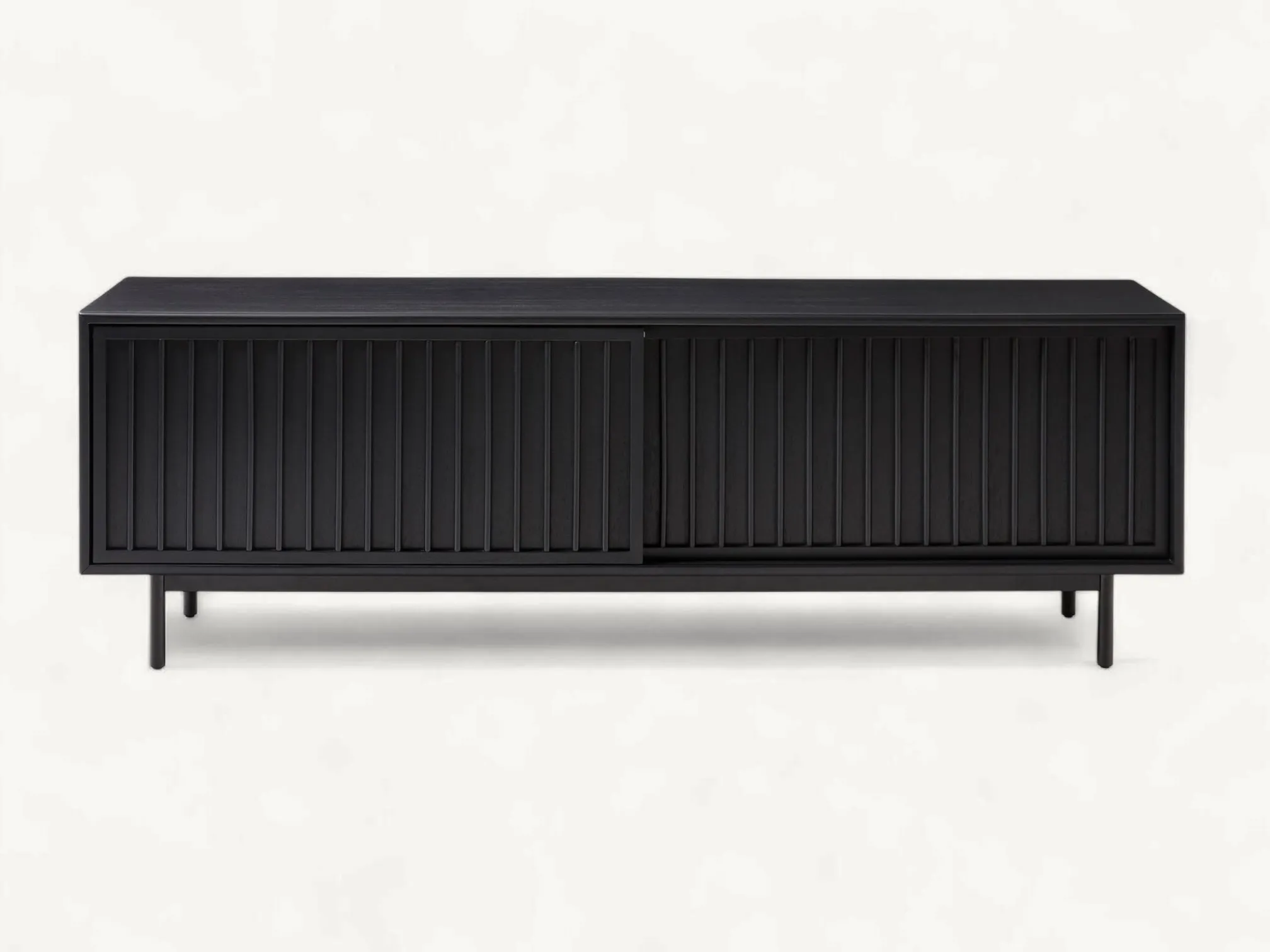 Mid-century teak wood TV console with vertical slatted sliding doors and slim black metal legs in a warm natural finish.