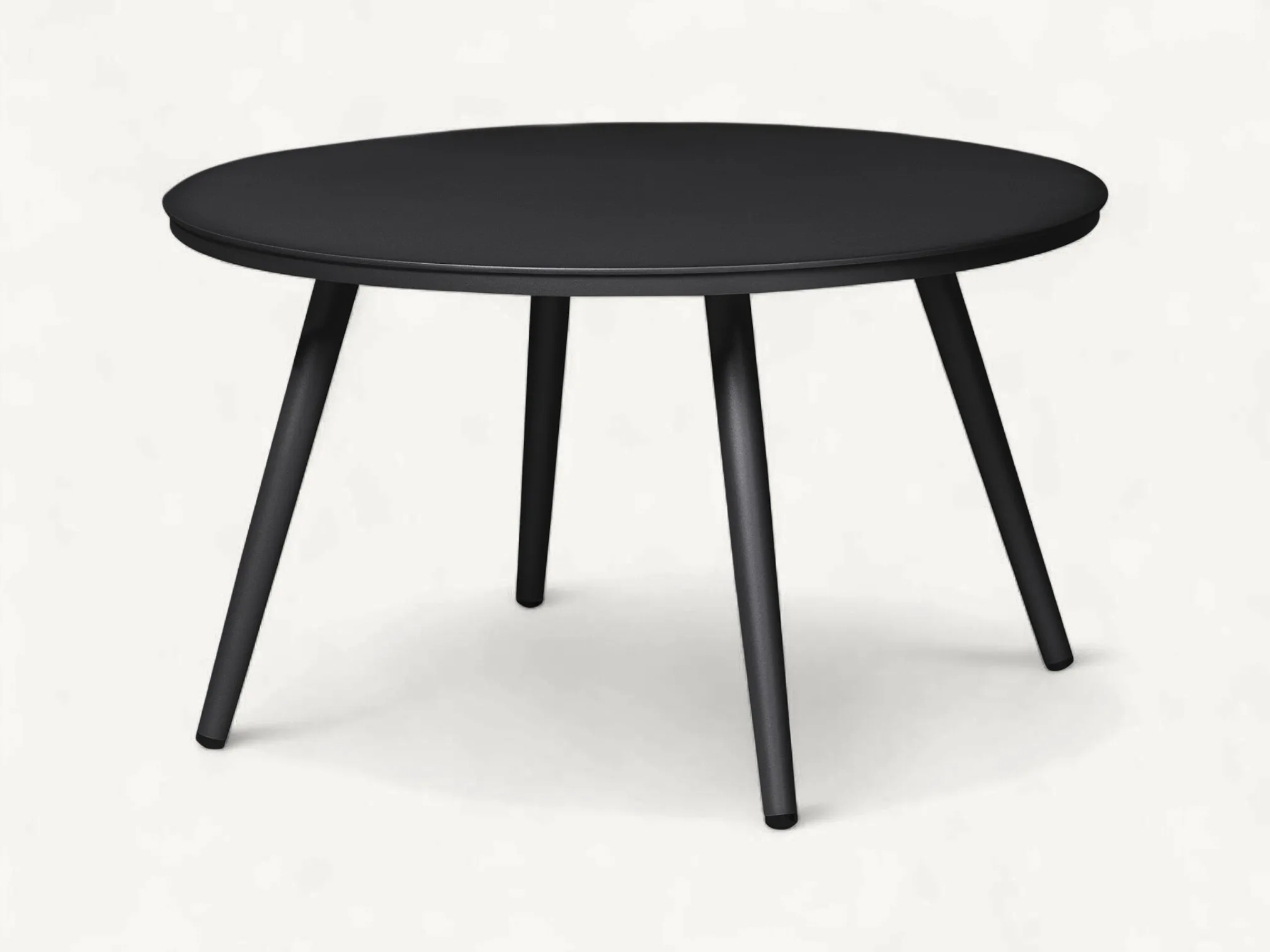 Scandinavian round outdoor coffee table in matte black stainless steel with four tapered legs.