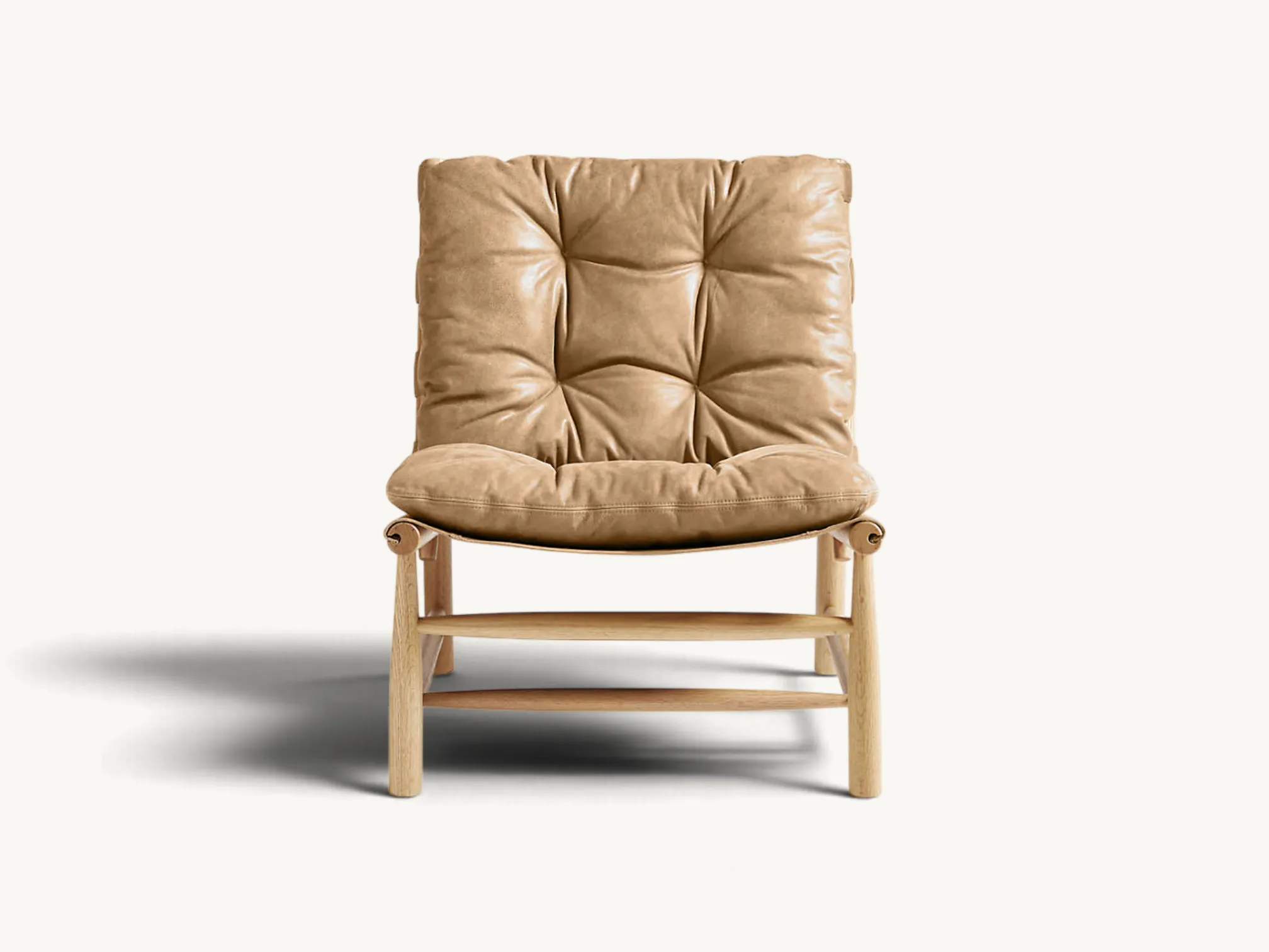 Low-profile accent chair featuring a natural light wood frame and plush tufted tan leather cushions