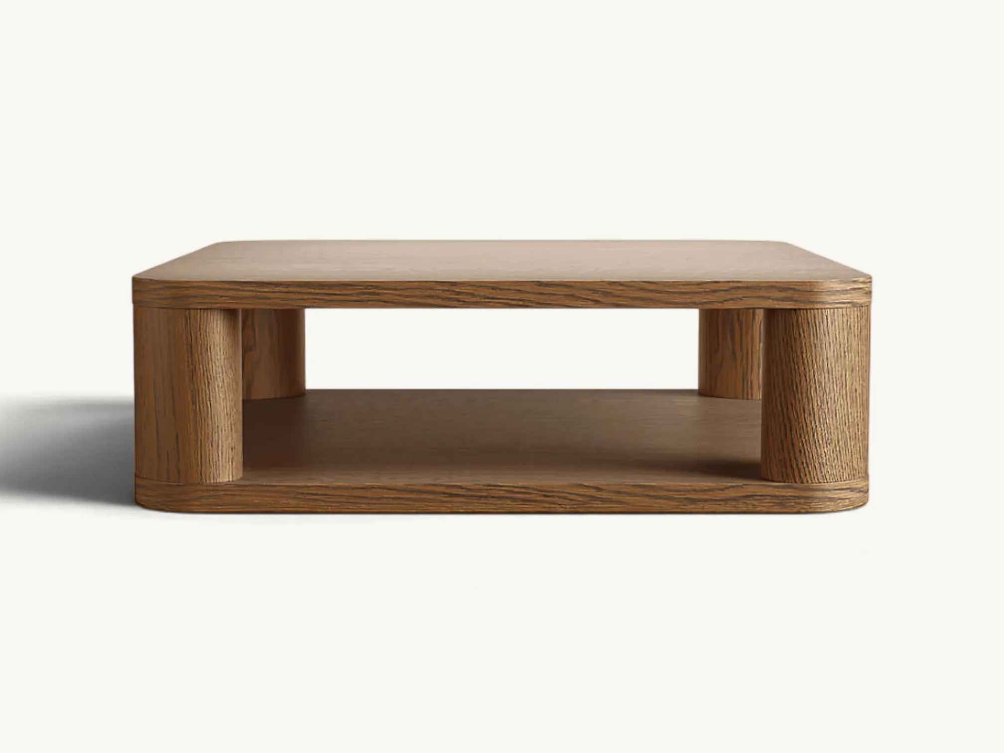 Low-profile square wooden coffee table with rounded corners, cylindrical corner legs, and a bottom open storage shelf