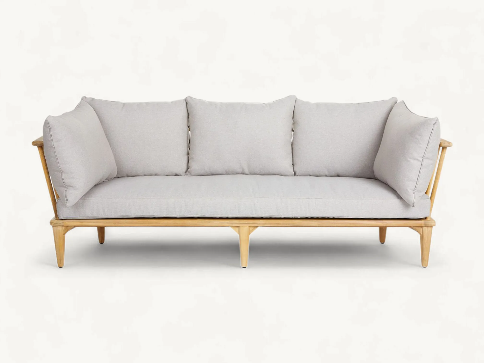 Scandinavian style solid teak wood outdoor sofa with spindle backrest and grey cushions.