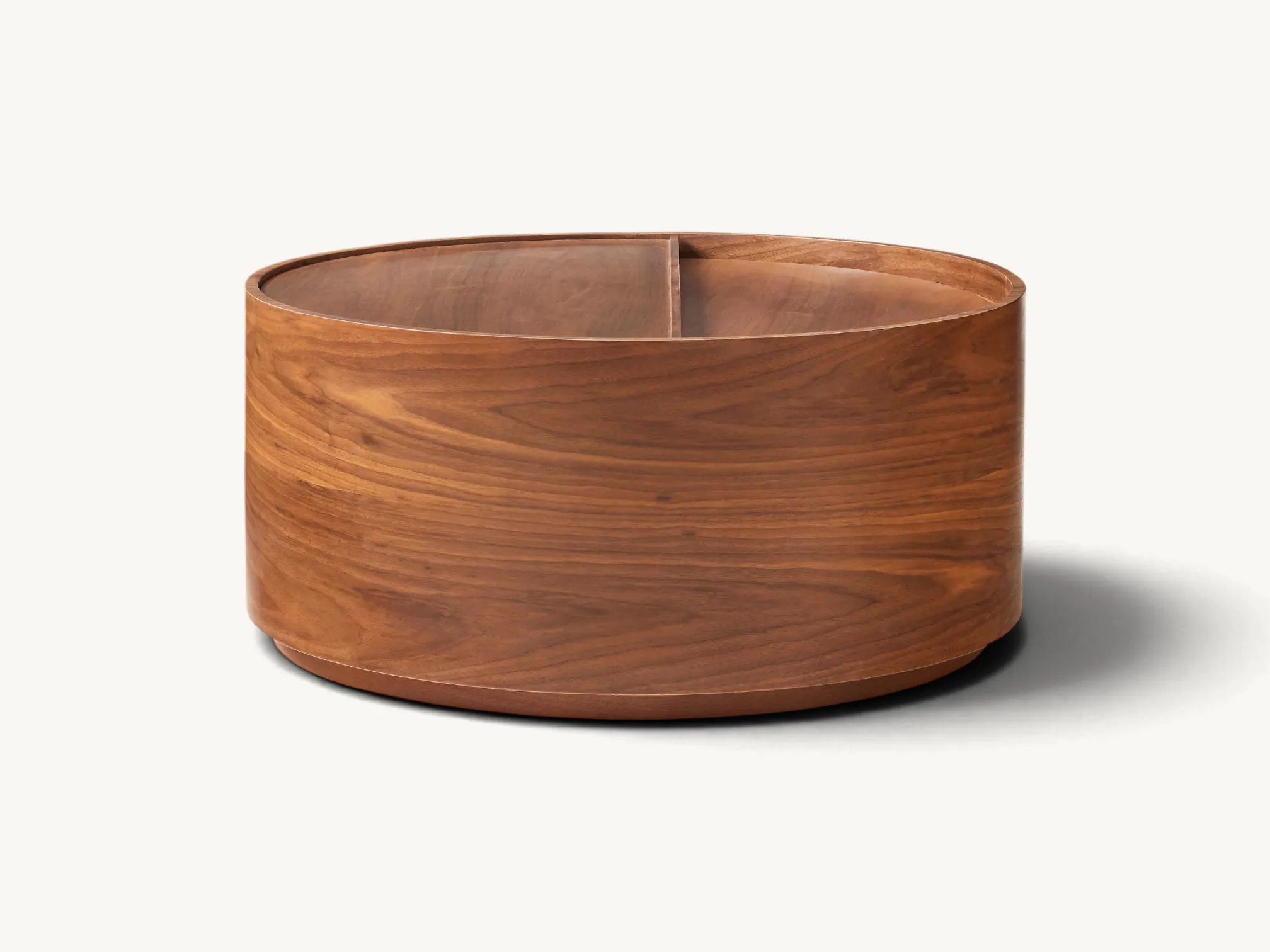 Modern round teak coffee table with hidden sliding storage compartment and natural wood grain finish.