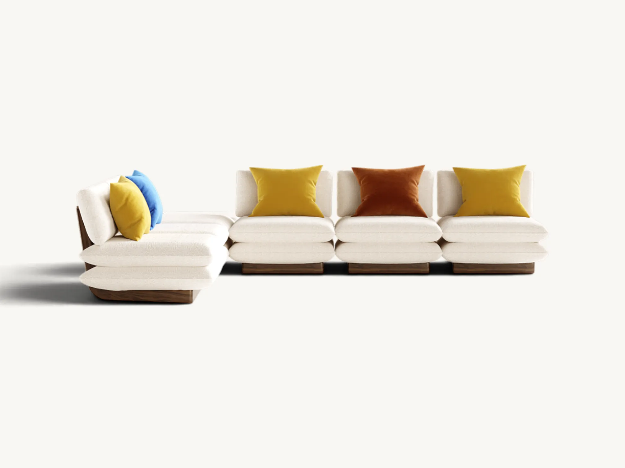 Mid-century modern modular sofa with curved walnut wood back panels, white cream upholstery, and colorful accent cushions.