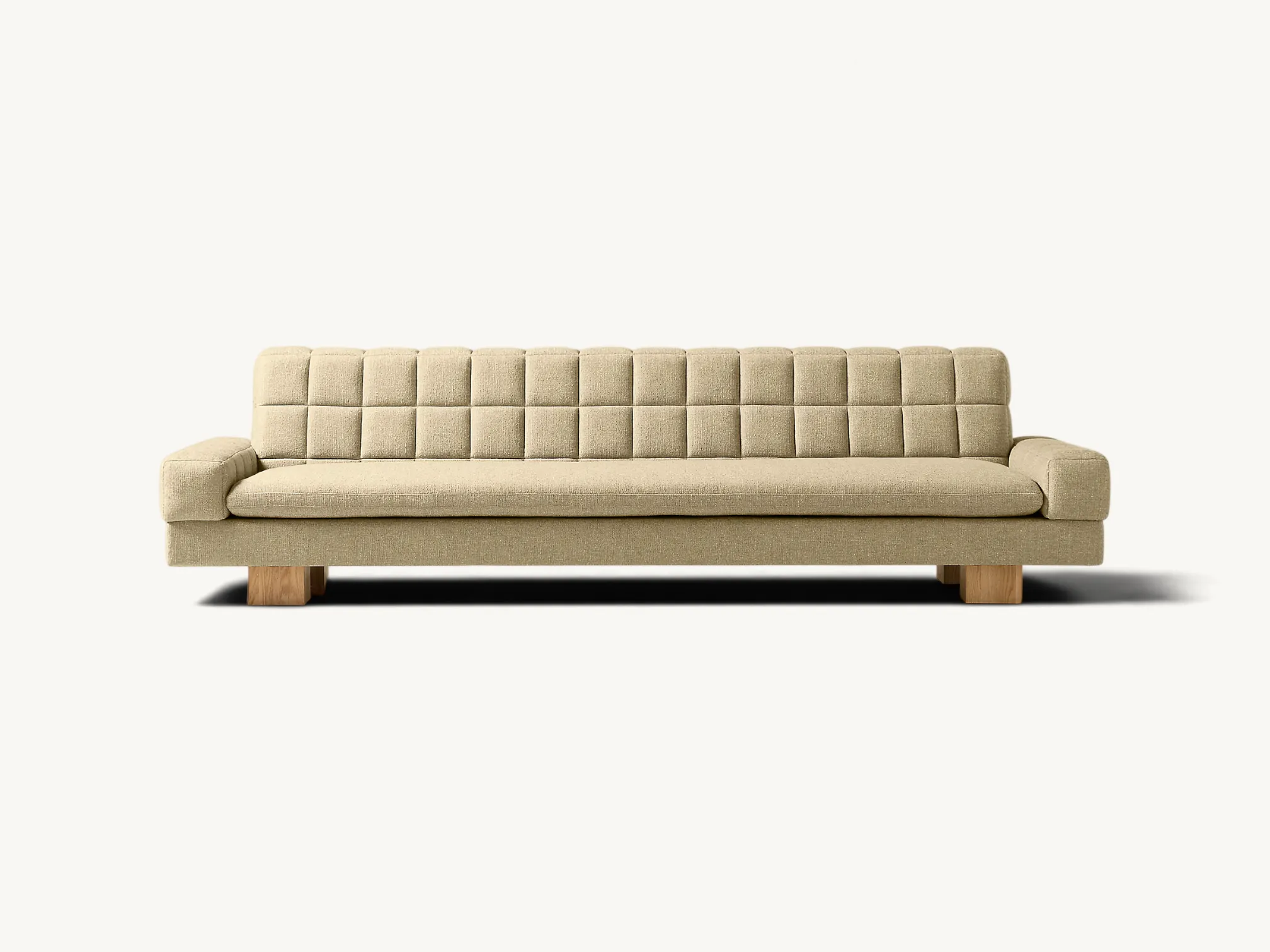 Minimalist curved sofa on an extended solid teak wood platform base with round legs.