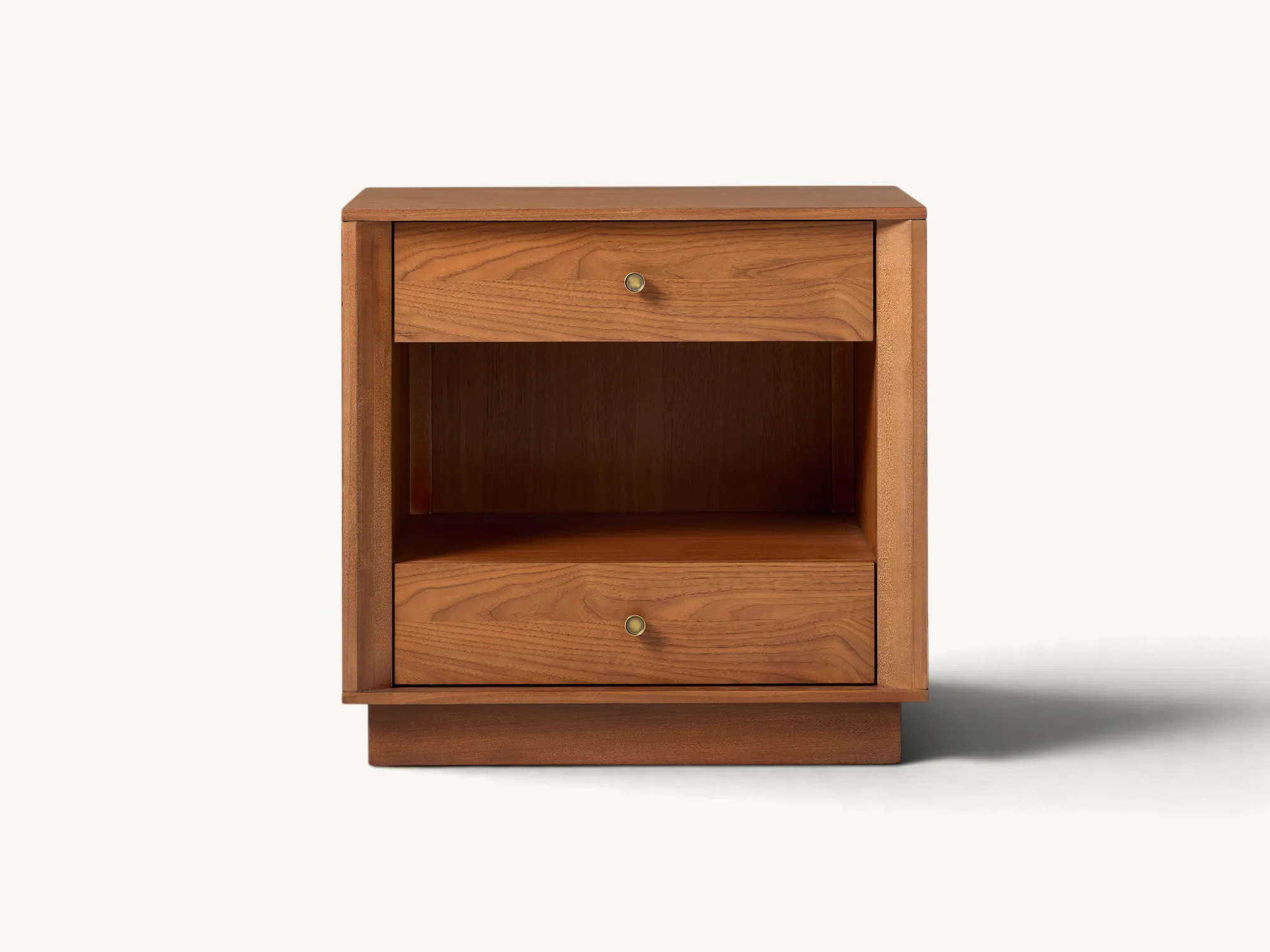 Solid teak wood bedside table featuring two drawers with brass knobs, an open center shelf, and a recessed plinth base.