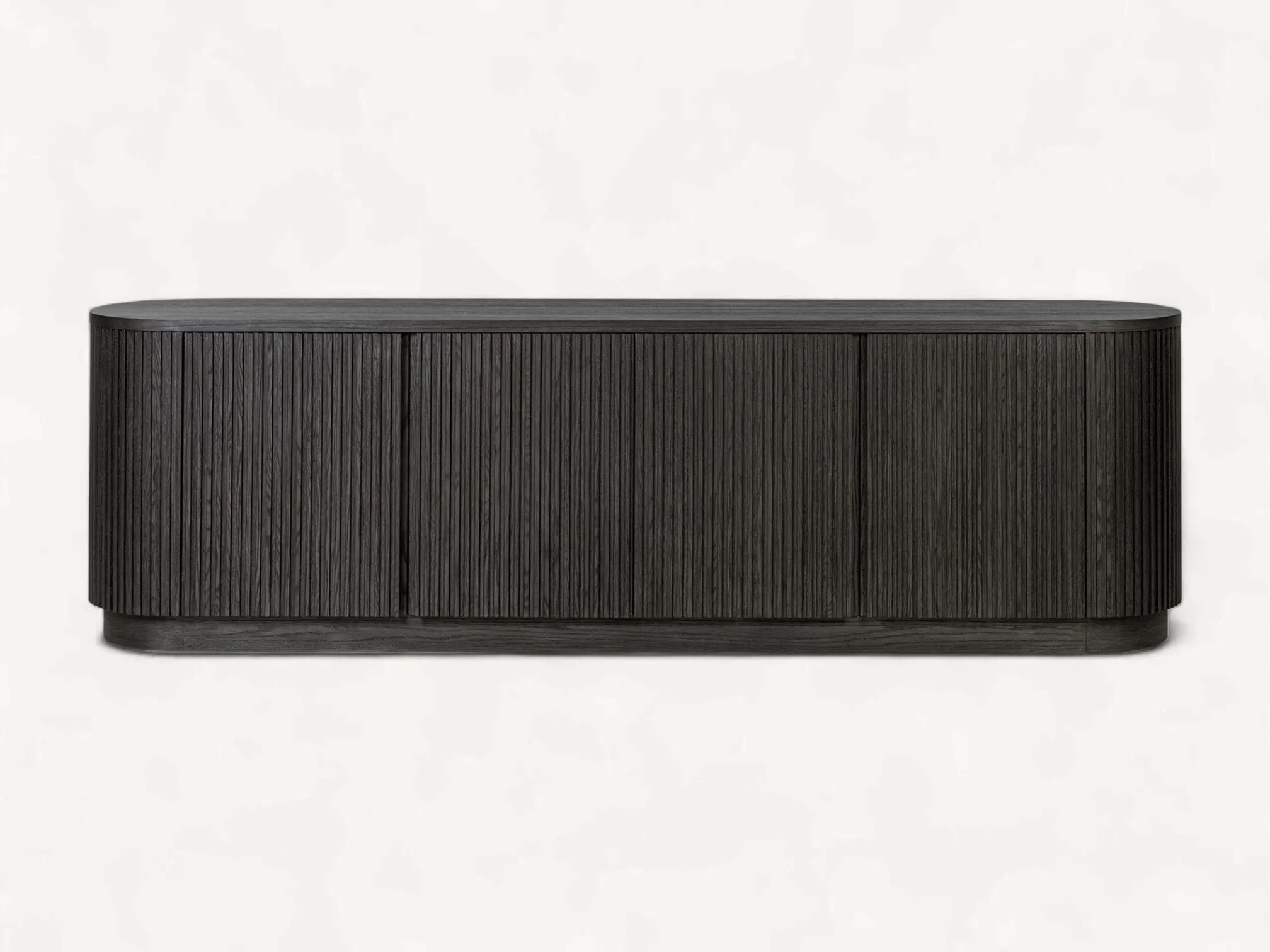 Modern charcoal black teak wood media console with rounded ends and vertical fluted tambour doors on a recessed plinth base.