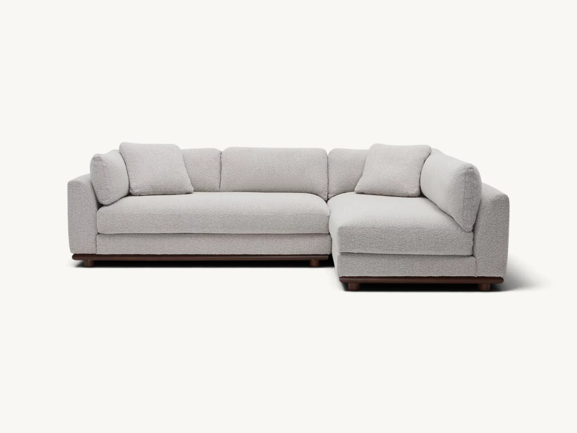 Modern low profile sectional sofa with plush textured upholstery and wooden base frame