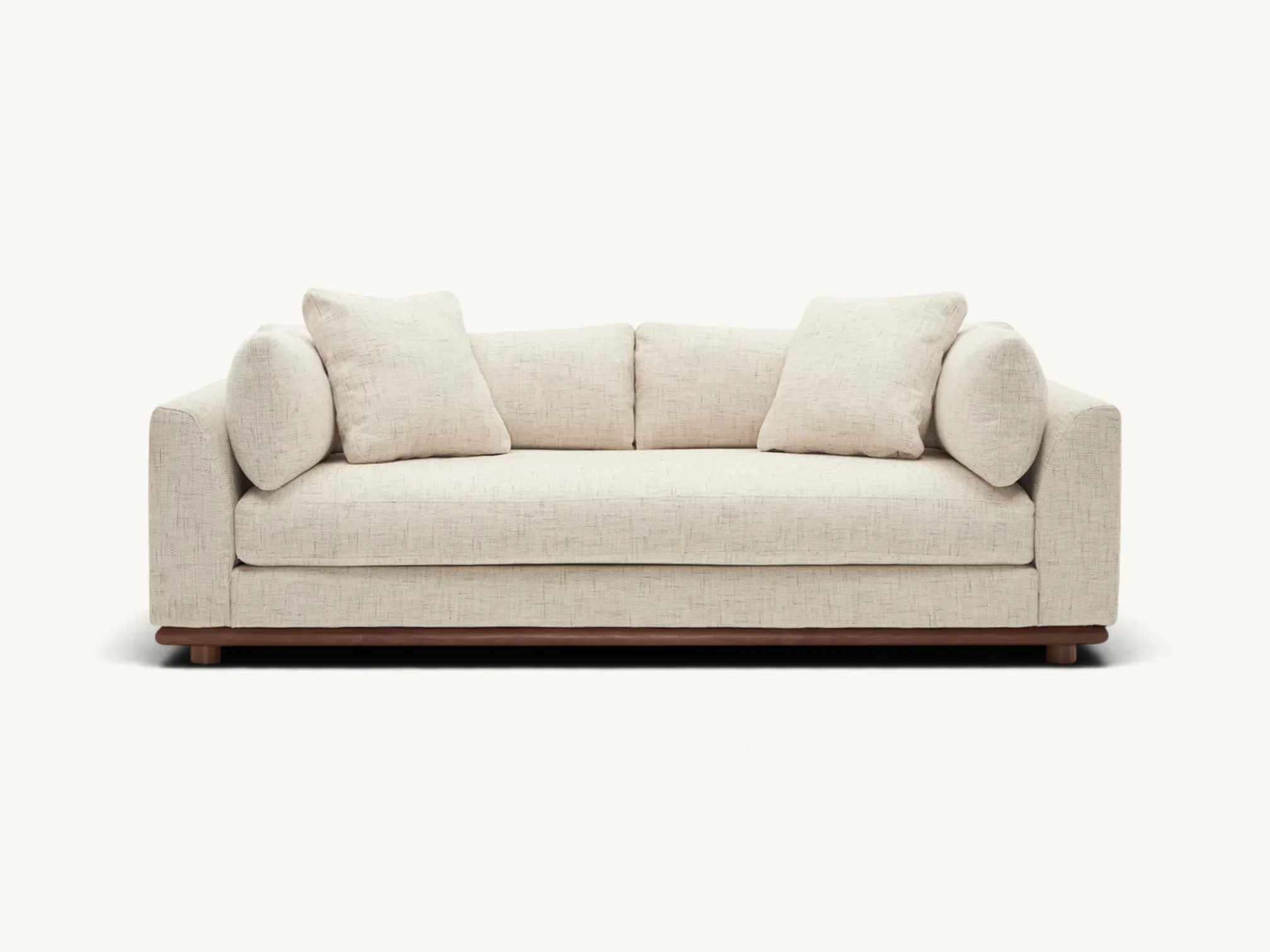 Low profile deep seat sofa with textured beige fabric upholstery and solid wood base