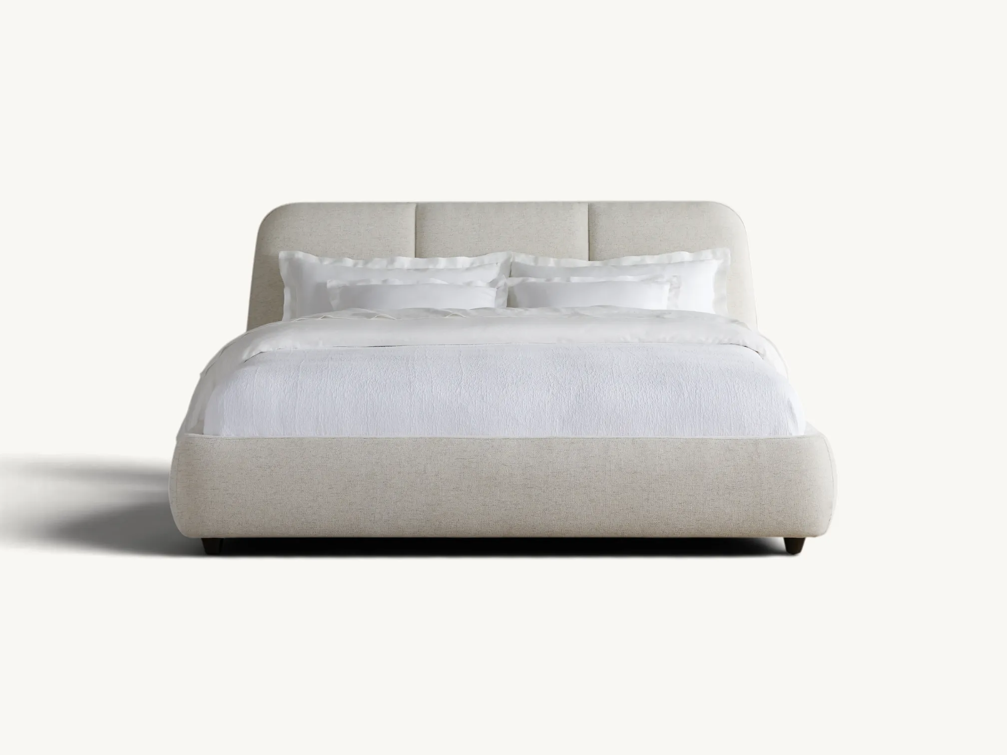 Minimalist upholstered platform bed in beige fabric with internal teak wood frame and low black metal legs.