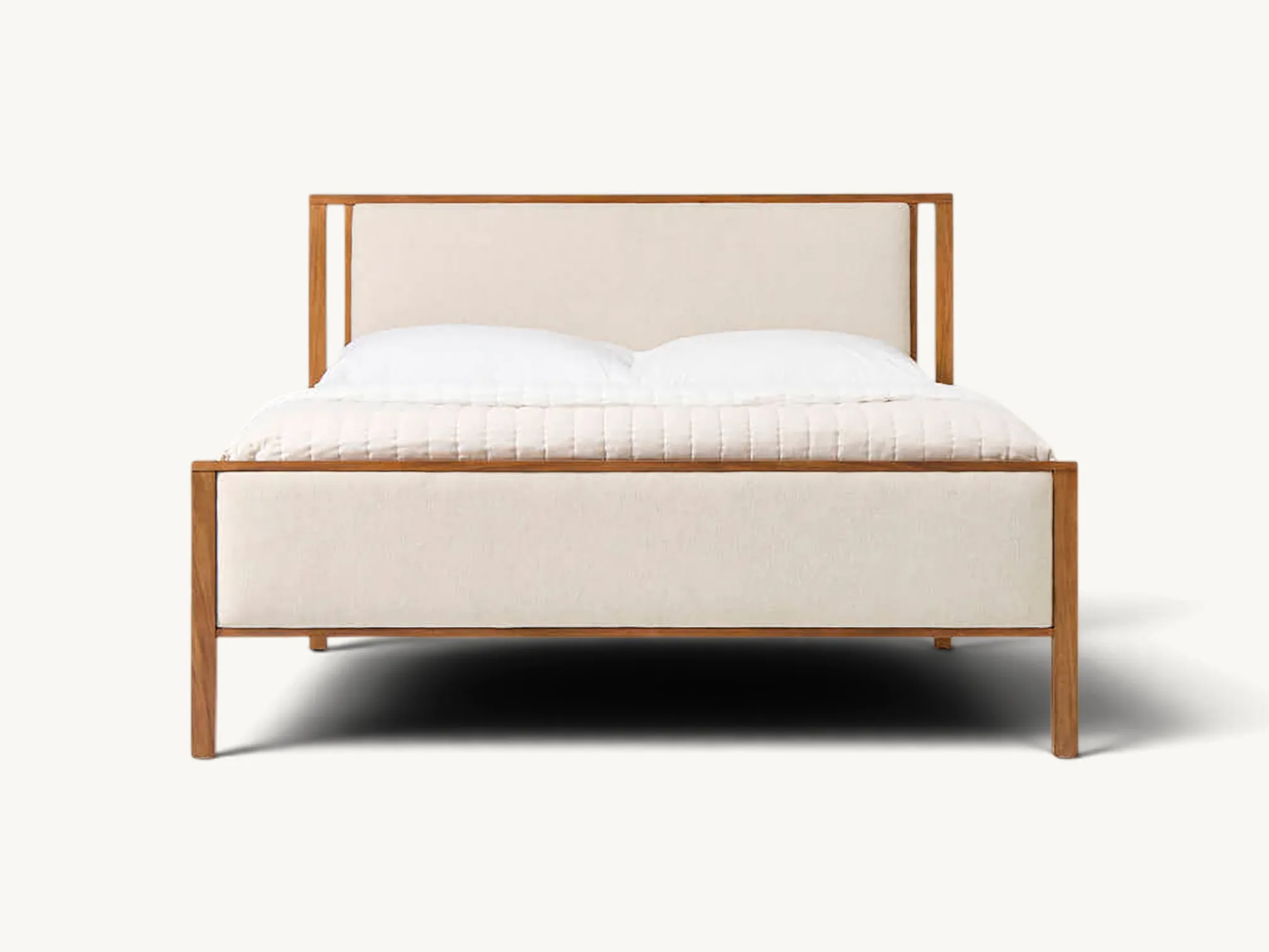 Scandinavian solid teak bed frame with cream upholstery and slim tapered legs.