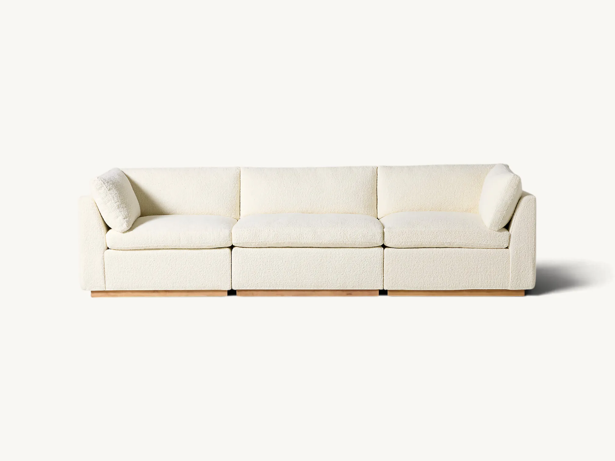 Modern three-piece modular sofa with a boxy minimalist design, white textured upholstery, and a slim solid teak wood base.