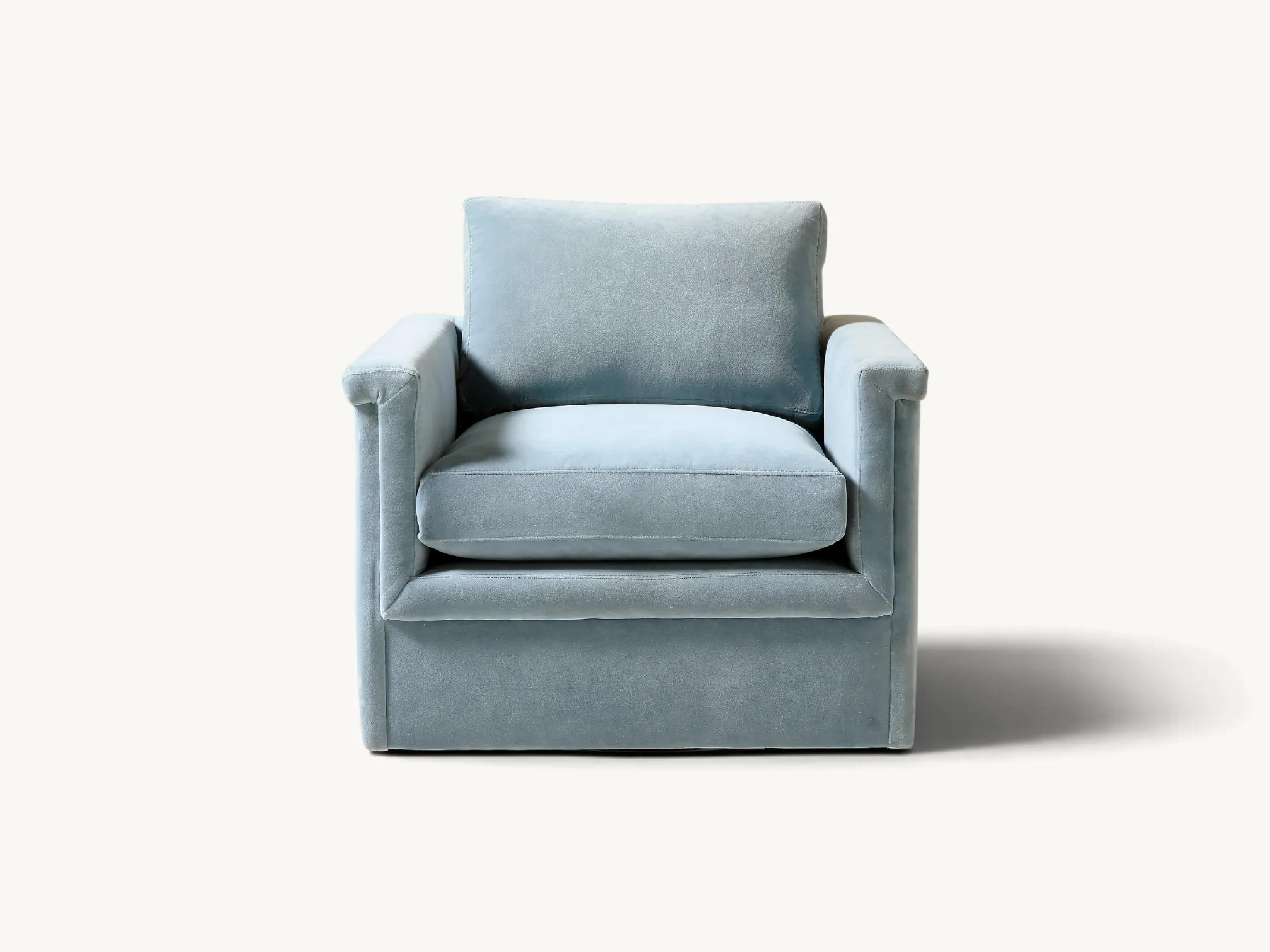 Light blue velvet single armchair with a clean rectangular design and plush cushions on a plain white background.