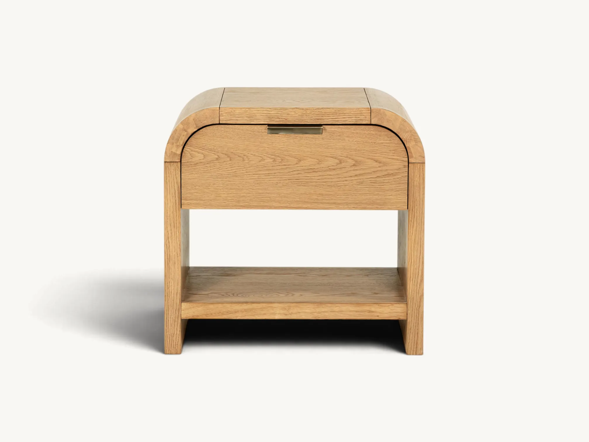 Light teak wood nightstand featuring a unique curved "waterfall" top edge, a single drawer with a brass tab pull, and an open bottom storage shelf.